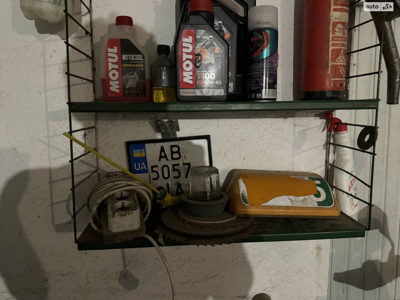 Старий номерний знак, а також антифриз у лівому верхньому кутку, який було залято у систему охолодження.