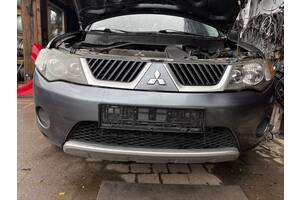 Вживаний бампер передній для Mitsubishi Outlander XL 2007-2009 Бампер продаєця комплектний як на фото.Під покраску.